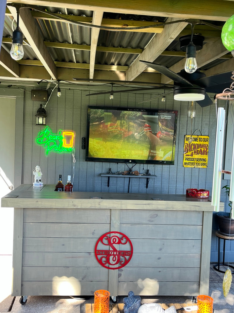 Gray horizontal wood bar beneath a deck with a television behind it