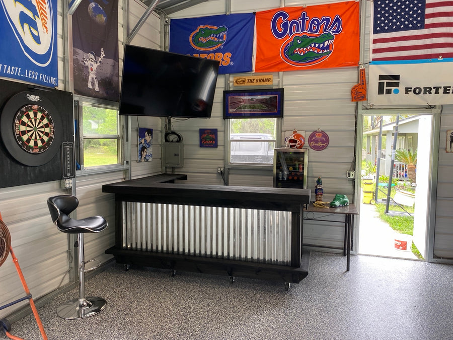 Dark-framed metal-front bar in a garage decorated with sports flags