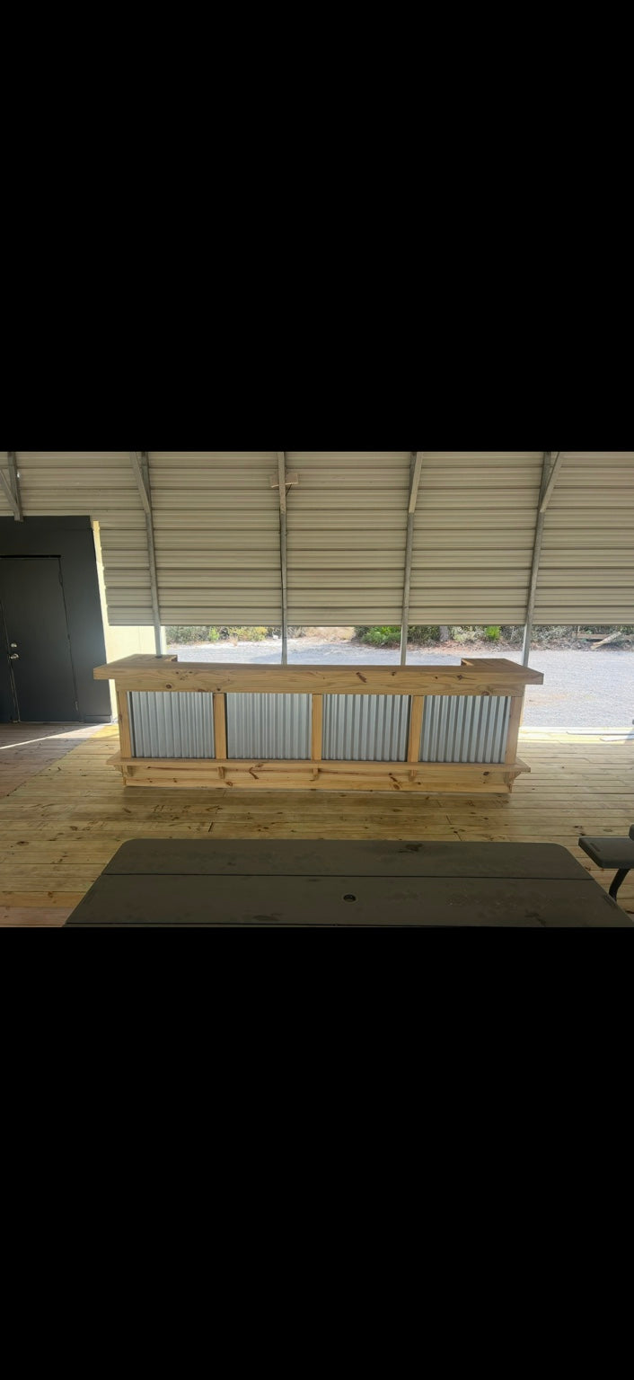 Long wood-framed corrugated metal bar in a covered outdoor structure